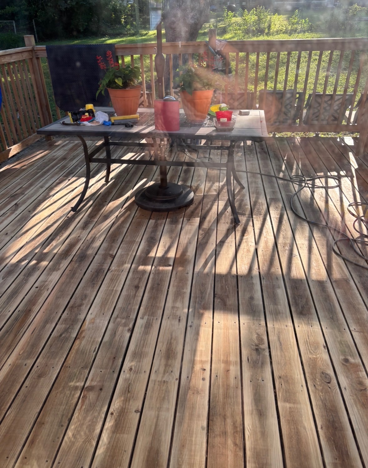 Weathered backyard deck with dirty, graying wood boards before cleaning